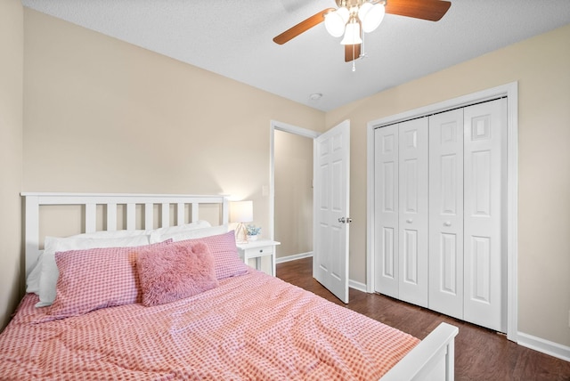 3387 Oak Park Dr, Clarksville, TN 37042 - bedroom with baseboards, dark wood-style flooring, a closet, and a ceiling fan