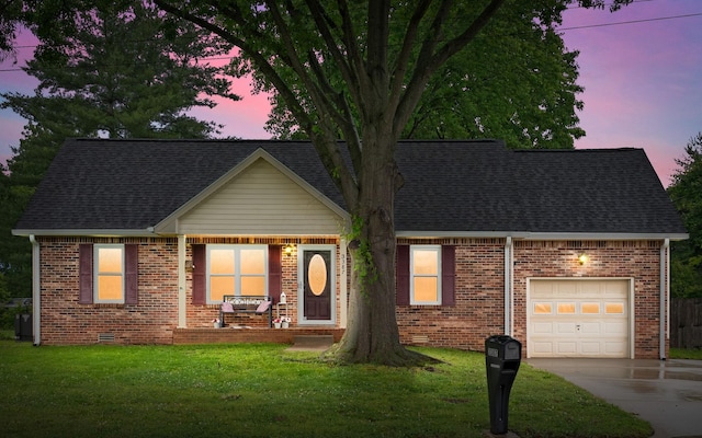 3387 Oak Park Dr, Clarksville, TN 37042 - view of front of house featuring brick siding, an attached garage, driveway, and a lawn