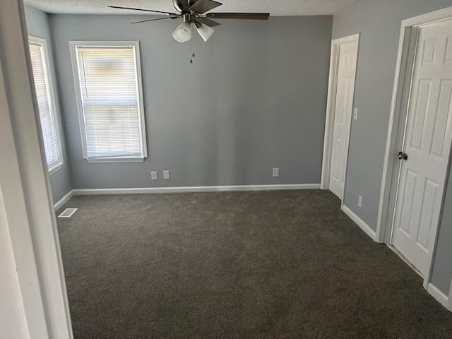 1047 Tylertown Rd, Clarksville, TN 37040 - unfurnished room featuring ceiling fan, dark colored carpet, a textured ceiling, and plenty of natural light