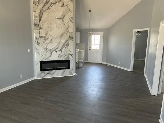 1047 Tylertown Rd, Clarksville, TN 37040 - unfurnished living room with baseboards, dark wood-style flooring, a high end fireplace, and high vaulted ceiling