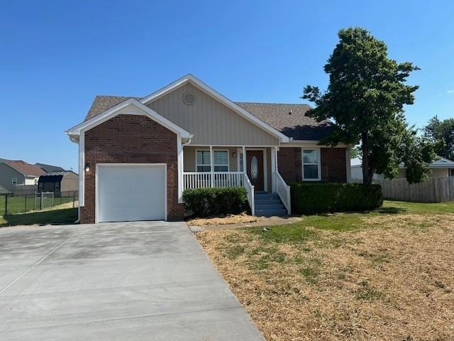 1047 Tylertown Rd, Clarksville, TN 37040 - single story home with covered porch, driveway, an attached garage, and brick siding
