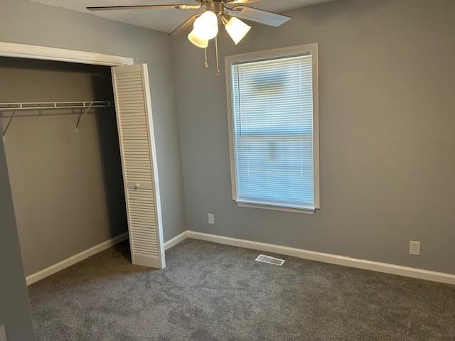 1047 Tylertown Rd, Clarksville, TN 37040 - unfurnished bedroom featuring carpet flooring, a closet, baseboards, and a ceiling fan