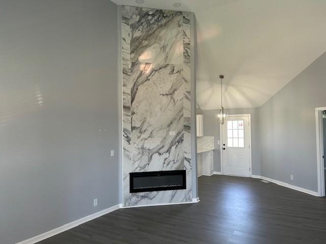 1047 Tylertown Rd, Clarksville, TN 37040 - unfurnished living room with dark wood-style floors, baseboards, a high end fireplace, a chandelier, and lofted ceiling