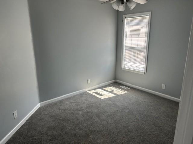 1047 Tylertown Rd, Clarksville, TN 37040 - spare room featuring dark colored carpet, plenty of natural light, ceiling fan, and baseboards