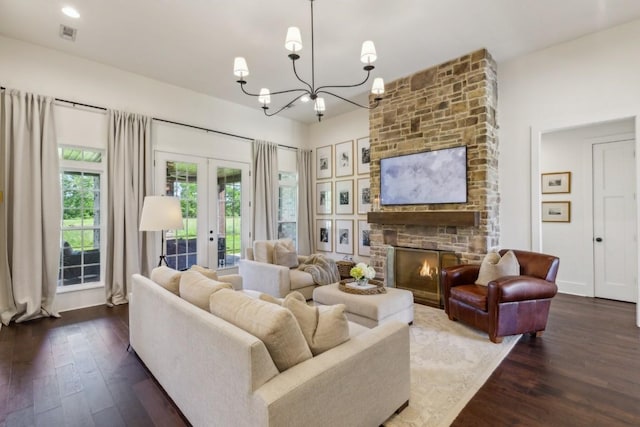 4034 Merryman Ln, Murfreesboro, TN 37127 - living area with dark wood finished floors, french doors, a chandelier, and a stone fireplace