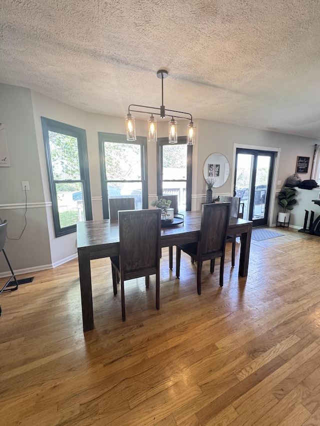 1111 Craig Moore Rd, Lewisburg, TN 37091 - dining space with light wood-style floors, a textured ceiling, and baseboards