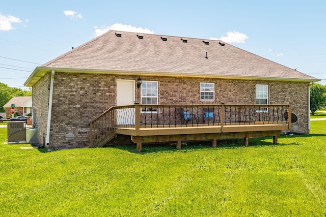 103 Alice Smith Dr, Portland, TN 37148 - back of property featuring a shingled roof, brick siding, a deck, and a yard