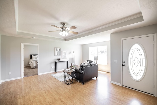 103 Alice Smith Dr, Portland, TN 37148 - foyer with a tray ceiling, ornamental molding, plenty of natural light, a ceiling fan, and light wood-type flooring