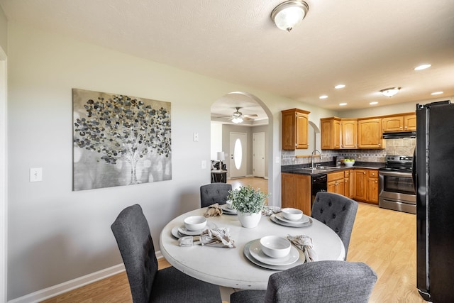 103 Alice Smith Dr, Portland, TN 37148 - dining space featuring arched walkways, light wood-style floors, ceiling fan, baseboards, and recessed lighting