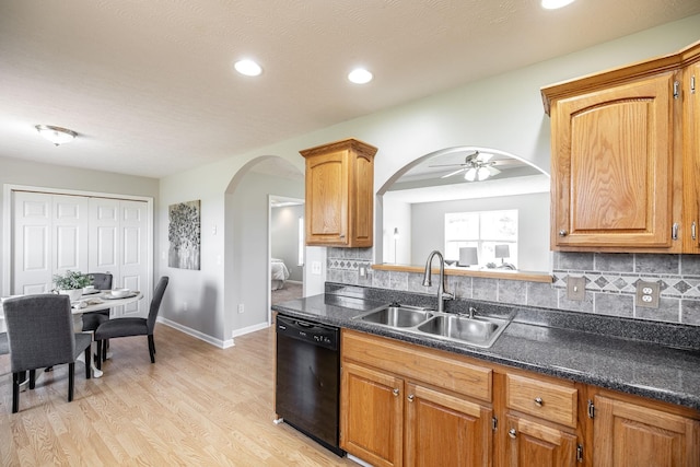 103 Alice Smith Dr, Portland, TN 37148 - kitchen featuring dishwasher, a sink, arched walkways, tasteful backsplash, and dark countertops