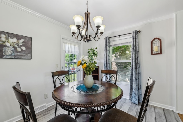 101 Townview Dr, Smyrna, TN 37167 - dining area with a chandelier, light wood-type flooring, baseboards, and crown molding