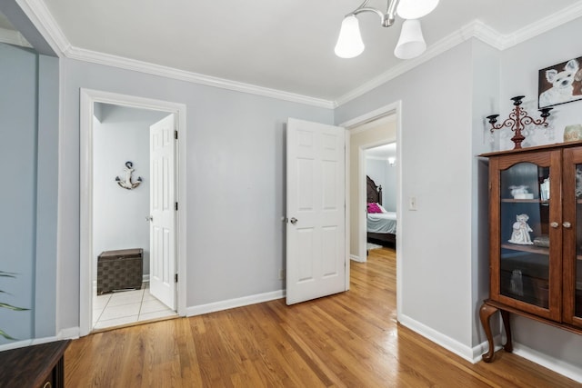 101 Townview Dr, Smyrna, TN 37167 - unfurnished bedroom featuring a chandelier, ornamental molding, light wood-style flooring, baseboards, and connected bathroom