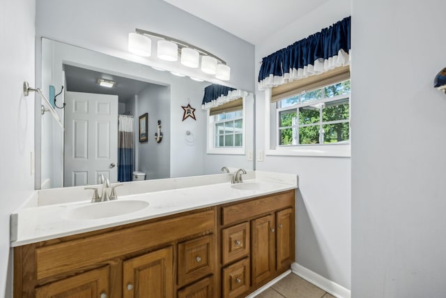 101 Townview Dr, Smyrna, TN 37167 - bathroom with double vanity, tile patterned floors, baseboards, and toilet