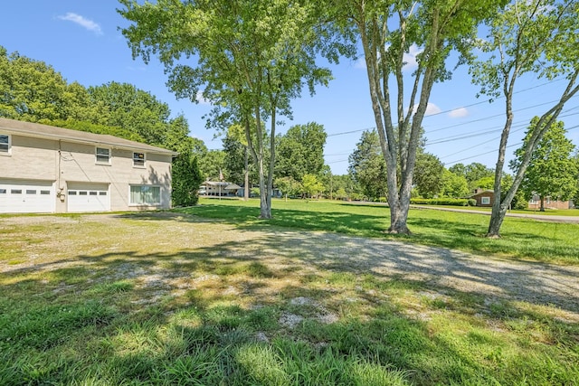 101 Townview Dr, Smyrna, TN 37167 - view of green lawn with a garage and view of scattered trees