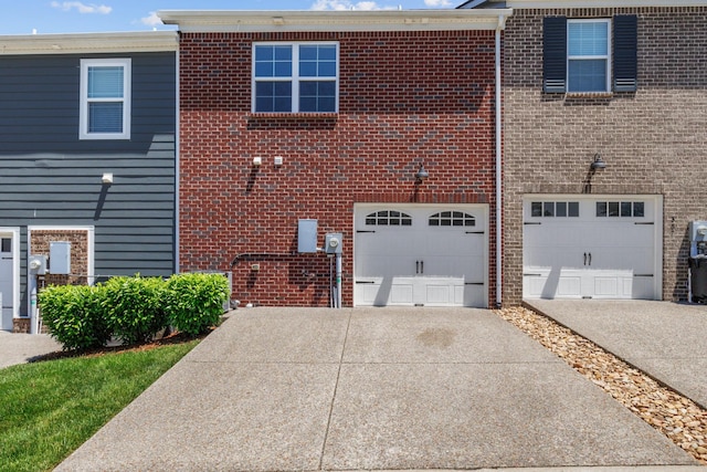 369 Carriage House Ln Unit L509, Hendersonville, TN 37075 - rear view of house featuring concrete driveway, a garage, and brick siding