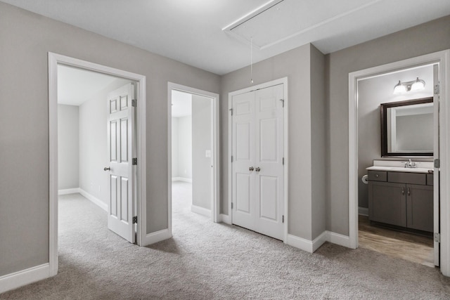 369 Carriage House Ln Unit L509, Hendersonville, TN 37075 - hallway featuring attic access, carpet flooring, baseboards, and a sink
