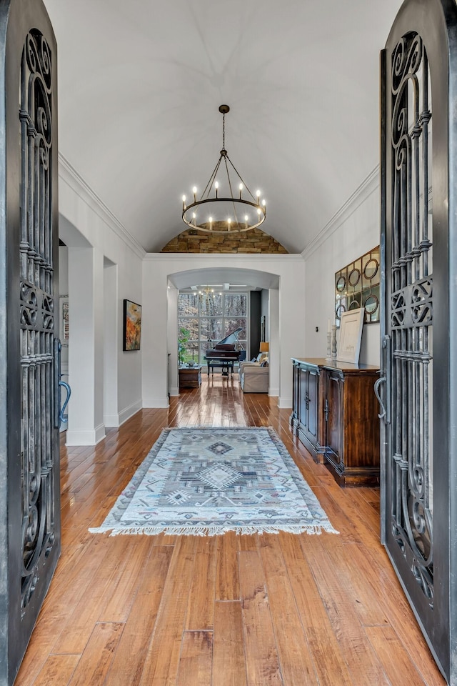 1120 Natchez Valley Ln, Franklin, TN 37064 - foyer with lofted ceiling, a chandelier, hardwood / wood-style floors, baseboards, and arched walkways