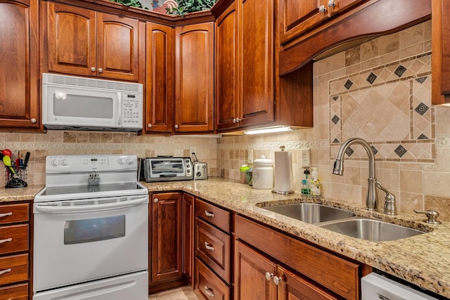 1120 Natchez Valley Ln, Franklin, TN 37064 - kitchen featuring white appliances, a sink, decorative backsplash, and light stone countertops