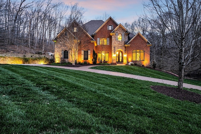 1120 Natchez Valley Ln, Franklin, TN 37064 - view of front facade featuring a yard, brick siding, and stone siding