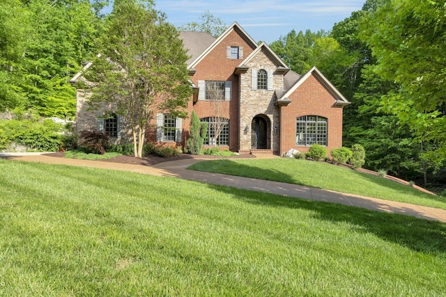 1120 Natchez Valley Ln, Franklin, TN 37064 - view of front of house with stone siding, a front yard, and brick siding