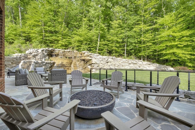1120 Natchez Valley Ln, Franklin, TN 37064 - view of patio featuring an outdoor fire pit and a wooded view