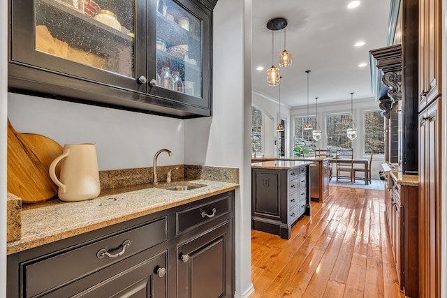 1120 Natchez Valley Ln, Franklin, TN 37064 - indoor wet bar with ornamental molding, light wood-style floors, pendant lighting, recessed lighting, and arched walkways