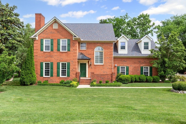 906 Knight Cir, Murfreesboro, TN 37129 - view of front facade featuring a chimney, brick siding, a front yard, and a shingled roof