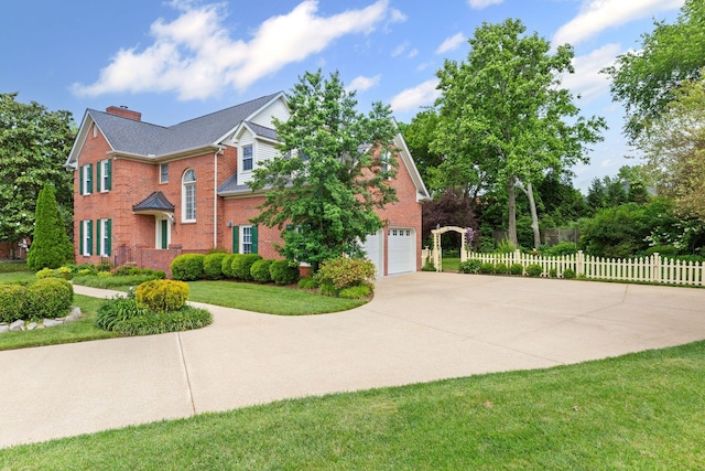 906 Knight Cir, Murfreesboro, TN 37129 - view of front facade with driveway, a chimney, brick siding, and an attached garage