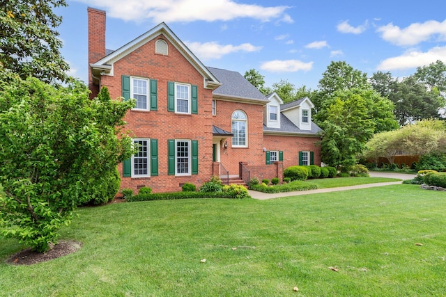 906 Knight Cir, Murfreesboro, TN 37129 - view of front of home featuring brick siding, a chimney, and a front yard