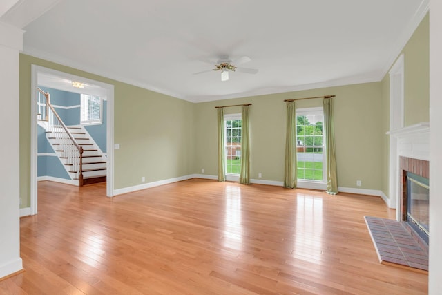 906 Knight Cir, Murfreesboro, TN 37129 - unfurnished living room featuring ceiling fan, healthy amount of natural light, a fireplace, stairway, and crown molding
