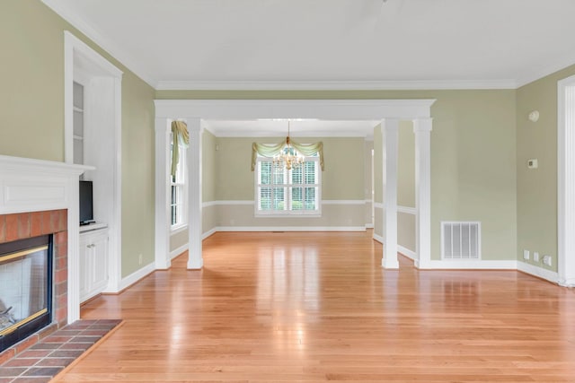 906 Knight Cir, Murfreesboro, TN 37129 - unfurnished living room with a tiled fireplace, light wood-style flooring, a chandelier, crown molding, and baseboards