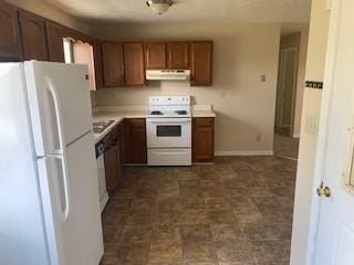 924 Linda Dr, Oak Grove, KY 42262 - kitchen featuring white appliances, under cabinet range hood, light countertops, and brown cabinets