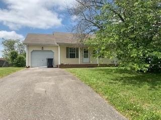 924 Linda Dr, Oak Grove, KY 42262 - view of front facade featuring driveway, a garage, a front lawn, and stucco siding