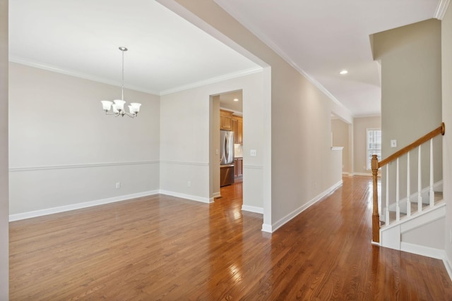 1120 Banbury Ln, Brentwood, TN 37027 - empty room featuring wood finished floors, ornamental molding, a chandelier, baseboards, and stairs