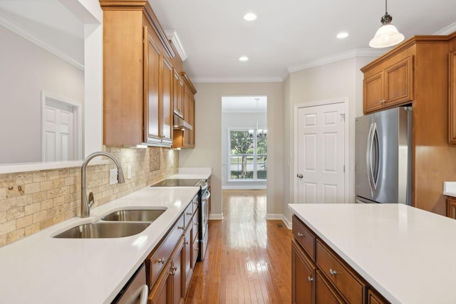 1120 Banbury Ln, Brentwood, TN 37027 - kitchen featuring stainless steel appliances, a sink, brown cabinets, tasteful backsplash, and hardwood / wood-style flooring