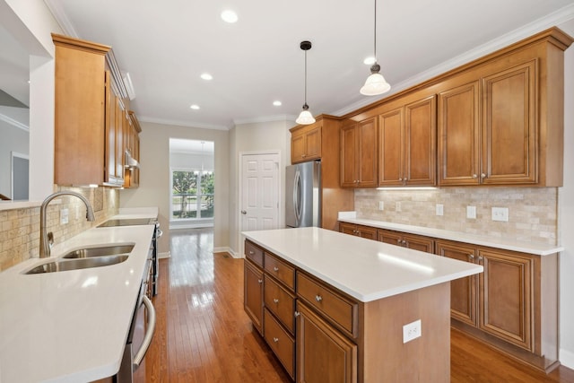 1120 Banbury Ln, Brentwood, TN 37027 - kitchen with a sink, stainless steel appliances, brown cabinets, recessed lighting, and ornamental molding