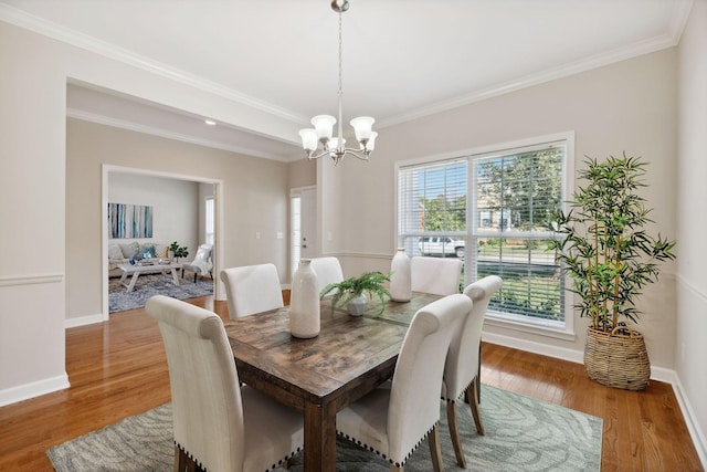 1120 Banbury Ln, Brentwood, TN 37027 - dining room with a chandelier, crown molding, wood finished floors, and baseboards