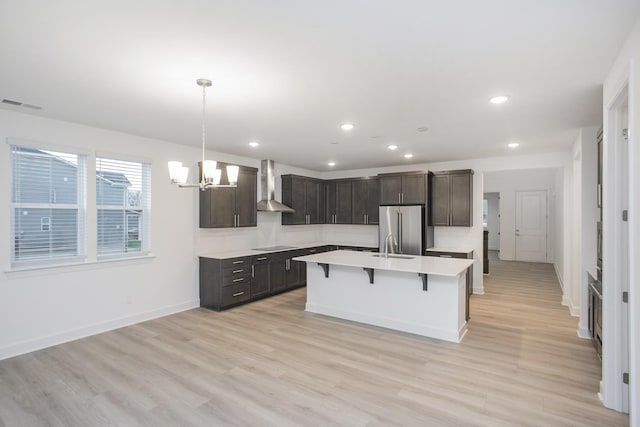 118 W Cassa Way, Mount Juliet, TN 37122 - kitchen featuring wall chimney exhaust hood, high end fridge, light countertops, a chandelier, and a kitchen breakfast bar