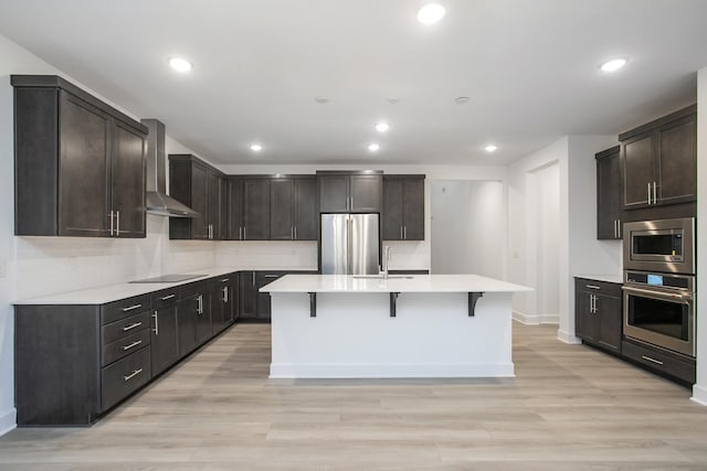 118 W Cassa Way, Mount Juliet, TN 37122 - kitchen with appliances with stainless steel finishes, wall chimney exhaust hood, baseboards, light countertops, and recessed lighting