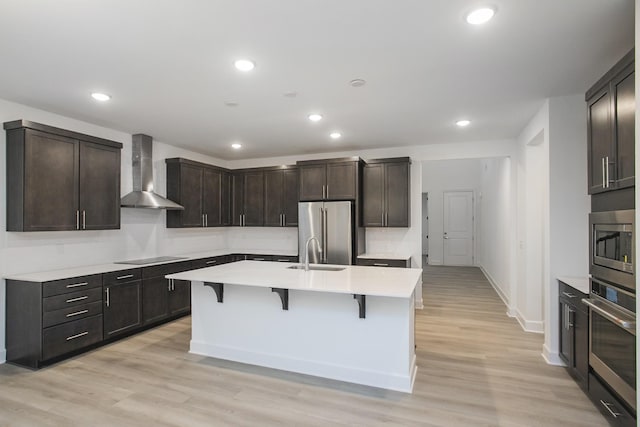 118 W Cassa Way, Mount Juliet, TN 37122 - kitchen featuring wall chimney exhaust hood, appliances with stainless steel finishes, a kitchen breakfast bar, a sink, and light countertops