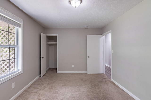 104 Evanmeade Dr, Smyrna, TN 37167 - unfurnished bedroom with carpet flooring, a closet, a textured ceiling, and baseboards
