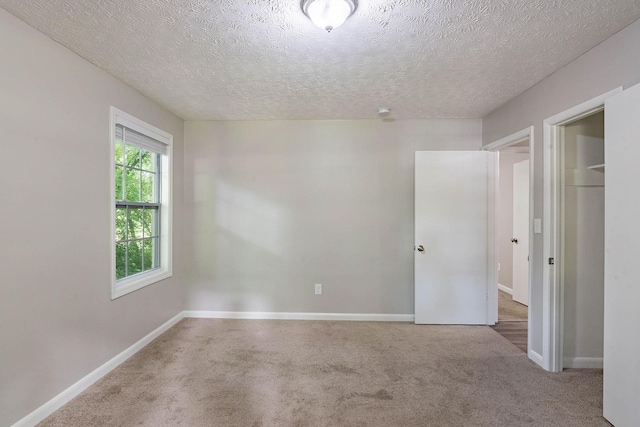 104 Evanmeade Dr, Smyrna, TN 37167 - unfurnished bedroom featuring a textured ceiling, carpet, and baseboards
