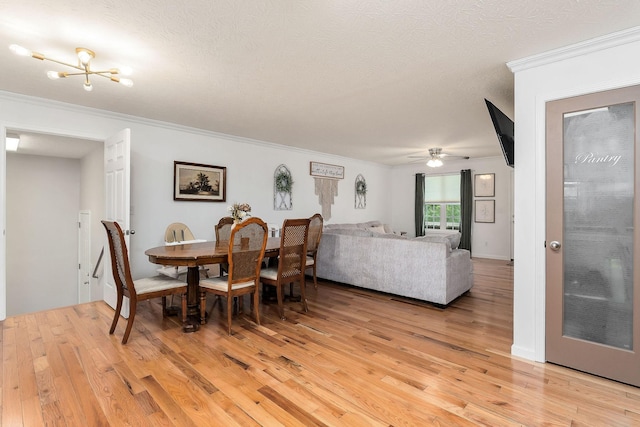 24 Hillcrest Dr, Sparta, TN 38583 - dining space with light wood-style flooring, crown molding, a textured ceiling, and a ceiling fan
