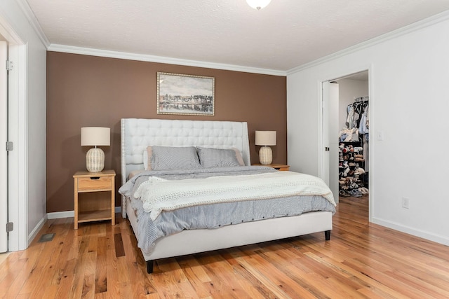 24 Hillcrest Dr, Sparta, TN 38583 - bedroom with ornamental molding, baseboards, light wood finished floors, a walk in closet, and a closet
