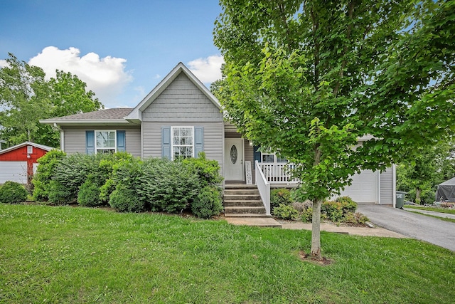 24 Hillcrest Dr, Sparta, TN 38583 - view of front facade featuring covered porch, driveway, a front yard, and a garage