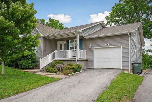 24 Hillcrest Dr, Sparta, TN 38583 - ranch-style house featuring a porch, roof with shingles, a garage, asphalt driveway, and a front lawn