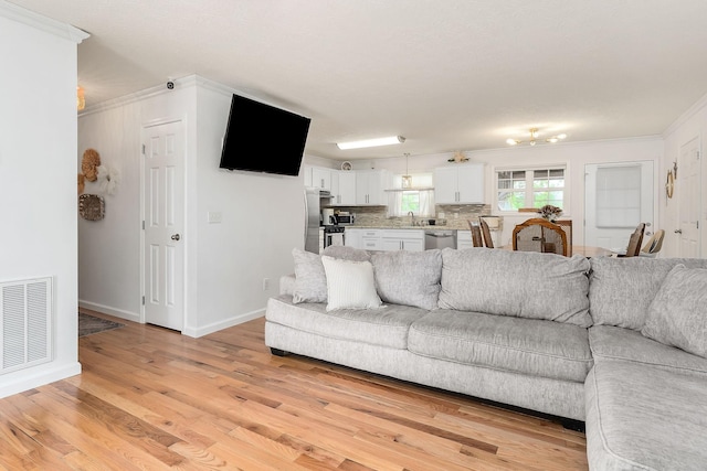 24 Hillcrest Dr, Sparta, TN 38583 - living room featuring light wood-style flooring, crown molding, and baseboards