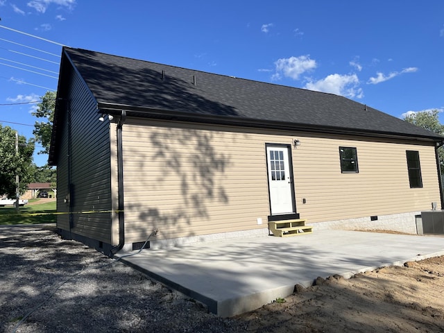 52 Hickman Hwy, Gordonsville, TN 38563 - back of property featuring entry steps, crawl space, a shingled roof, and a patio area