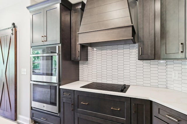 1373 Southside Rd, Southside, TN 37171 - kitchen with black electric stovetop, premium range hood, stainless steel double oven, decorative backsplash, and light countertops