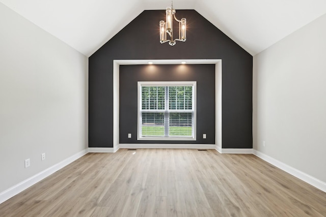 1373 Southside Rd, Southside, TN 37171 - empty room featuring a chandelier, wood finished floors, lofted ceiling, and baseboards